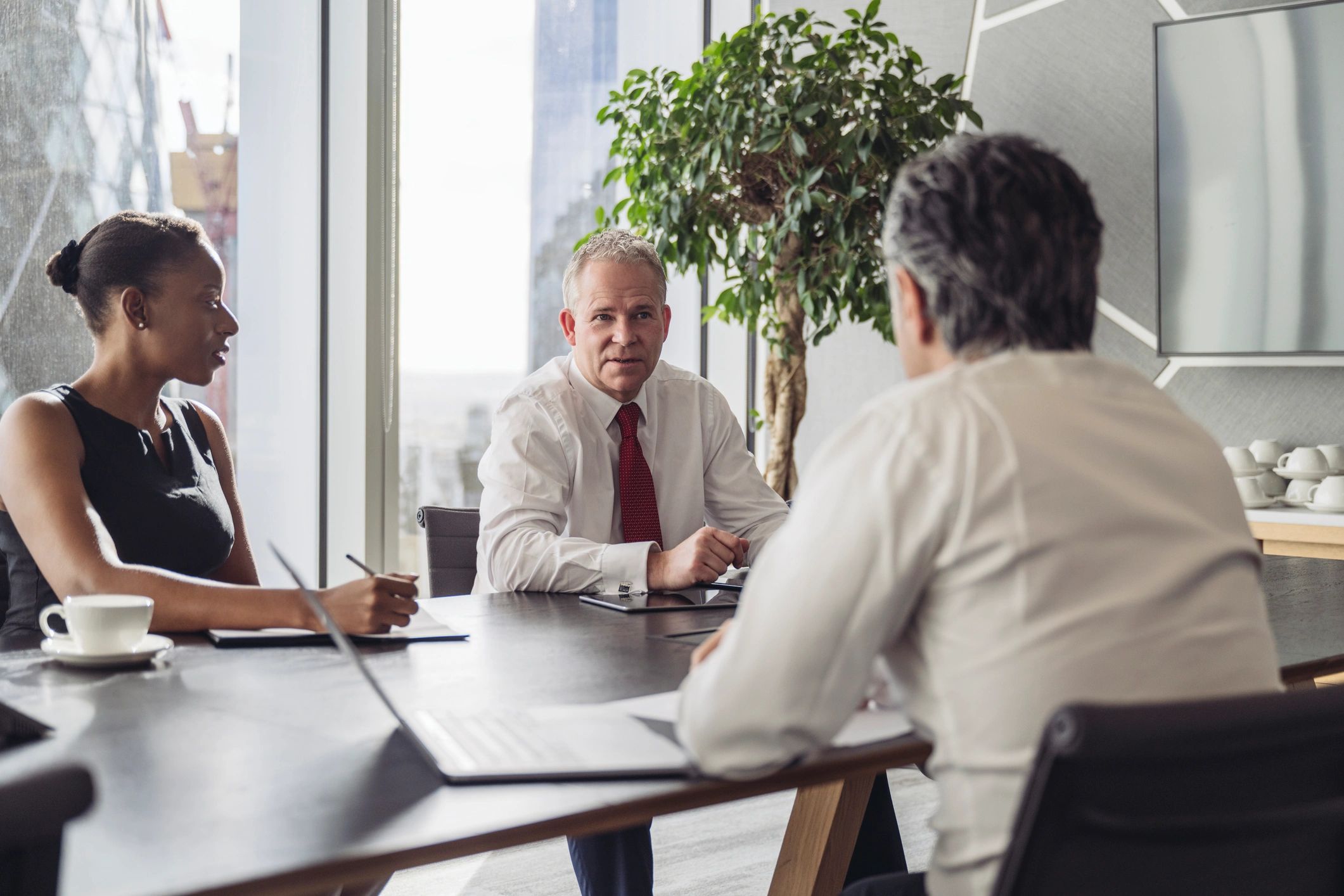 Consultancy team discussing communications strategy in a boardroom